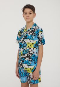 Pigiama a maniche corte con motivo graffiti, caratterizzato da colori nero, blu, giallo e bianco; materiale leggero, vestibilità casual, grafiche audaci.