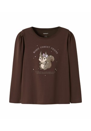 Chemise marron à manches longues avec épaules bouffantes, représentant un écureuil pailleté portant un nœud et le texte "Magic Forest Friend" au-dessus.