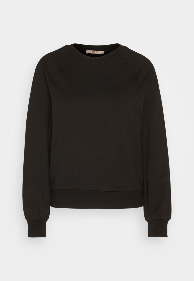 Sweatshirt noir avec un col rond, de longues manches raglan, des poignets élastiques et un ourlet ajusté. Fabriqué en tissu doux, au design minimaliste.