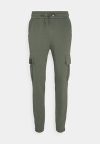 Olivgrüne Jogginghosen aus weichem Material. Mit elastischem Bund, verstellbarem Kordelzug und zwei seitlichen Cargo-Taschen.
