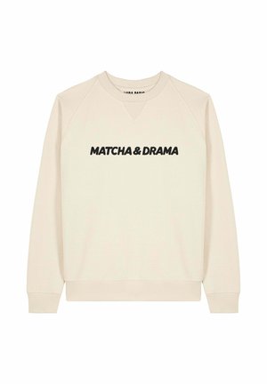 Felpa beige con scollo a V, maniche raglan e testo nero "MATCHA & DRAMA" sul petto. Tessuto morbido e polsini a costine.