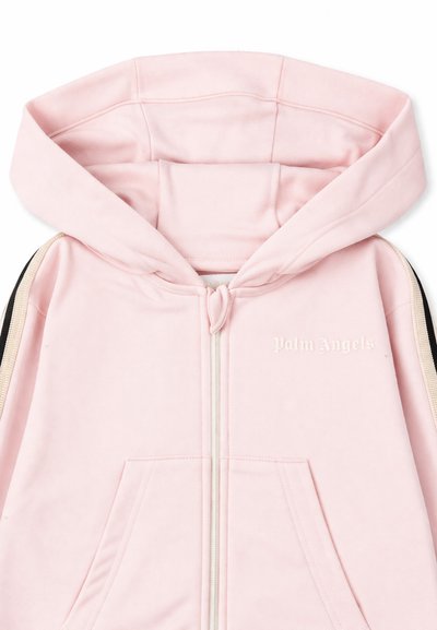 Sweat à capuche zippé rose clair avec manches rayées noires et blanches et logo "Palm Angels" sur la poitrine.