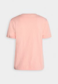 T-shirt à manches courtes en coton doux, léger et rose pâle. Il présente un col rond classique et un ourlet droit, sans embellissements supplémentaires.