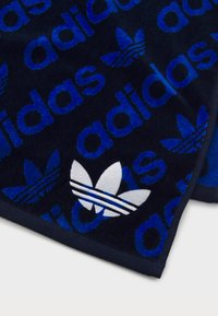 Dark navy towel featuring a textured pattern of blue "adidas" text and a white logo with three stripes and a three-leaf design.