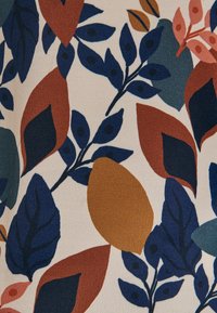 Tissu floral présentant des feuilles éparses en vert foncé, bleu marine, orange brûlé et rose pâle sur un fond crème. Surface texturée.