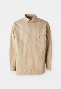 Striped shirt in beige with blue lines, button-up front, classic collar, single chest pocket with logo, long sleeves, and smooth texture.