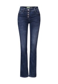 Jeans de mezclilla de color azul oscuro, con pierna acampanada y cintura alta, cierre frontal con cinco botones y dos bolsillos delanteros. Textura suave con ligero desgastado.