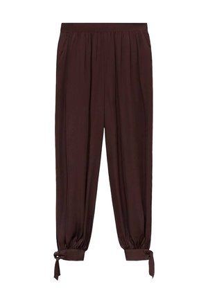 Bruine, lichte, taps toelopende broek met een elastische tailleband en gestrikte boorden. Gladde textuur en geplooid ontwerp over de hele benen.