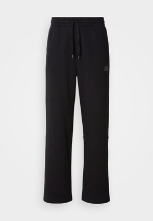 Black sweatpants made of soft fabric, featuring a drawstring waistband, straight legs, and a discreet brand logo on the side.