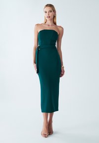 Teal strapless midi-mekko, jossa on jäsennelty yläosa ja sivuöljy yksityiskohta. Sujuva kangas, istuva Siluetti ja halkio helman kohdalla.