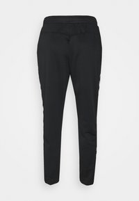 Zwarte sportieve broek met een taps toelopende pasvorm, elastische tailleband en zijstrepen. Gemaakt van gladde stof met een matte textuur.