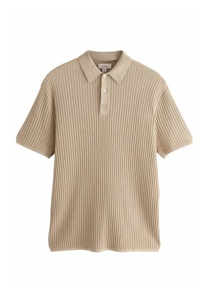 Polo de color beige con trama acanalada, cuello, tapeta de tres botones y mangas cortas. Fabricado en tejido de punto texturizado.