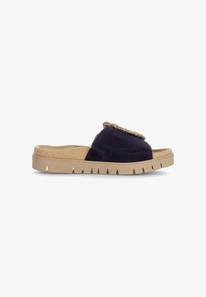 Navy blue slide sandal with tan cushioned sole, grooved outsole for grip, and decorative braided embellishment on upper strap.