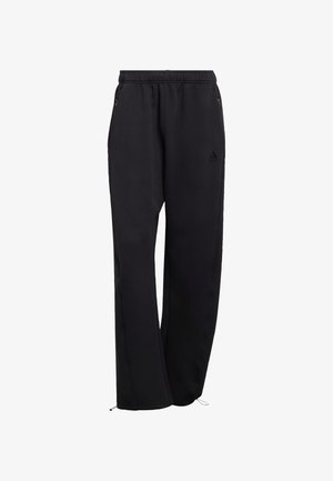 Czarne spodnie dresowe wykonane z miękkiego materiału, z elastycznym pasem, bocznymi kieszeniami oraz regulowanymi mankietami przy kostkach. Dyskretne logo.