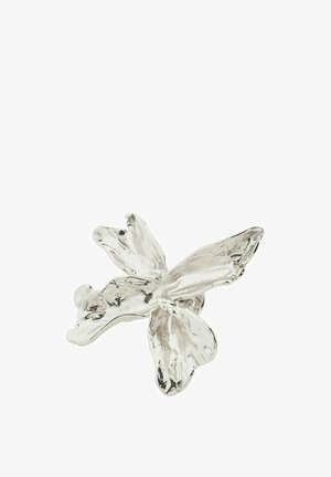 Silver flower-shaped sculpture with five petals, smooth texture, and shiny finish, resembling an orchid. Detailed with soft curves and organic shapes.