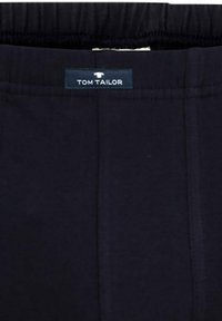 Donkerblauwe elastische tailleband broeken met een stoffen label met de tekst "TOM TAILOR." Kenmerkt zich door subtiele stiksels langs de naden en een zachte textuur.