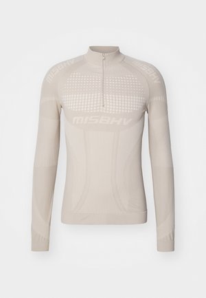 Maglietta beige a maniche lunghe con zip a quarto, caratterizzata da pattern testurizzati e un design aderente, realizzata in materiale elasticizzato per il comfort.