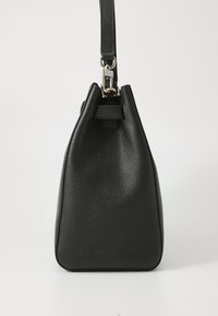 Black leather handbag with a textured finish, triangular shape, adjustable shoulder strap, and gold hardware accents.