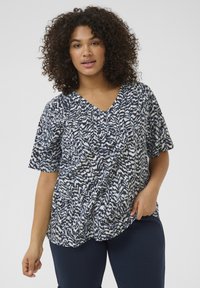 Top a maniche corte blu navy e bianco con motivo, scollatura a V e dettagli plissettati, realizzato in tessuto leggero. Progettato per il comfort.