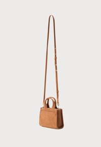 Small brown corduroy handbag with a rectangular shape, featuring a long adjustable strap and two short handles, silver hardware, and structured design.