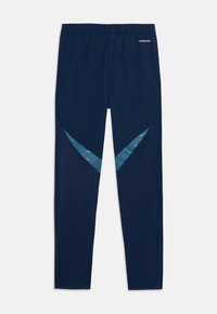 Tums zila sporta bikses ar elastīgu jostu un zilu ševrona ieliktņu uz augšstilbiem, pie jostas norādīts "AEROREADY".