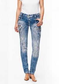 Jeans in denim azzurro chiaro con vestibilità slim, caratterizzati da cuciture decorative, due tasche frontali e un lavaggio sbiadito per un effetto texture.