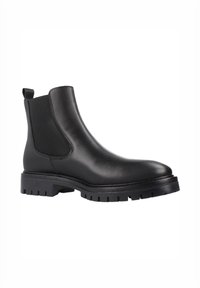 Botín Chelsea de cuero negro con paneles elásticos laterales, tirador y suela robusta. Presenta una punta redondeada y una textura suave.