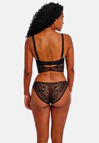 Black lace lingerie set featuring a bralette with adjustable straps and hook closure, complemented by matching lace briefs with floral patterns.