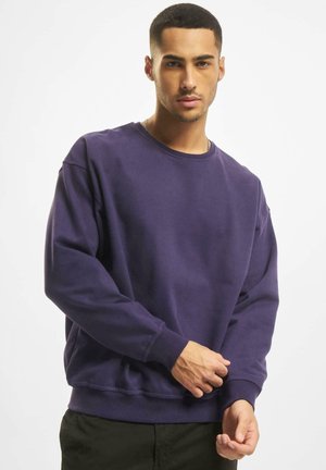 Lila Sweatshirt mit Rundhalsausschnitt, langen Ärmeln und gerippten Bündchen. Weicher Stoff, mit gesteppten Details und einer lässigen Passform.