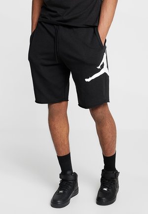 Czarne bawełniane szorty z białym logo Jumpman, wyposażone w talię ze sznurkiem, boczne kieszenie i luźny krój.