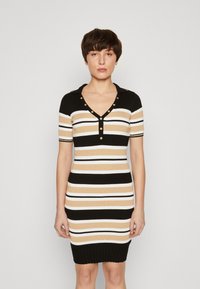 Abito in maglia con strisce orizzontali in nero, bianco e beige, dotato di un collo e bottoni decorativi in tono oro. Design aderente.
