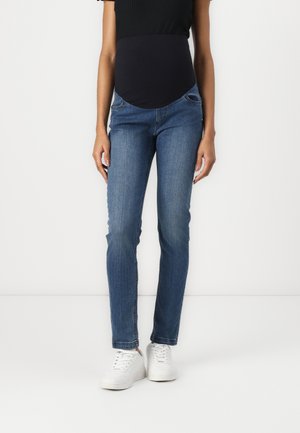 Maternity skinny jeans in medium blue denim, featuring a stretchable black panel at the waist, side pockets, and a slim fit design.