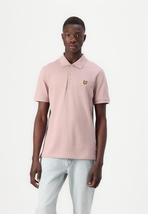 Korte mouwen polo shirt in zachtroze katoen, met een drieknoopsluiting en een geel vlinderlogo geborduurd op de borst.