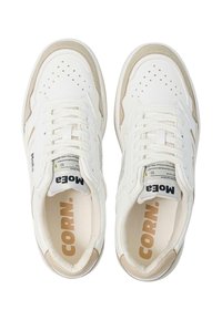 White sneakers with a smooth leather finish, perforated toe for breathability, beige accents, and a cushioned insole featuring "CORN." logo.