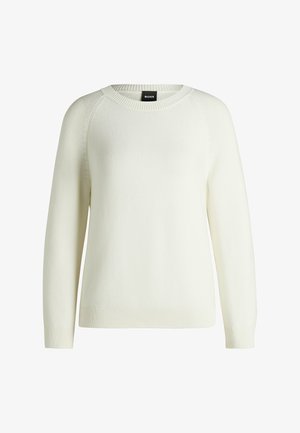 Witte gebreide trui met een ronde hals, ribgebreide manchetten en zoom. Heeft een gestructureerd patroon en raglanmouwen.