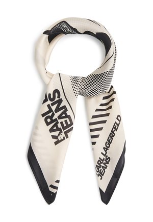Écharpe en soie couleur crème avec texte graphique noir "KARL LAGERFELD JEANS" et motifs abstraits de points et de rayures, nouée en un nœud lâche.