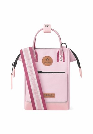 Pink fabric bag with a textured surface, short handles, and a detachable striped strap. Features a round logo and zippered pocket.
