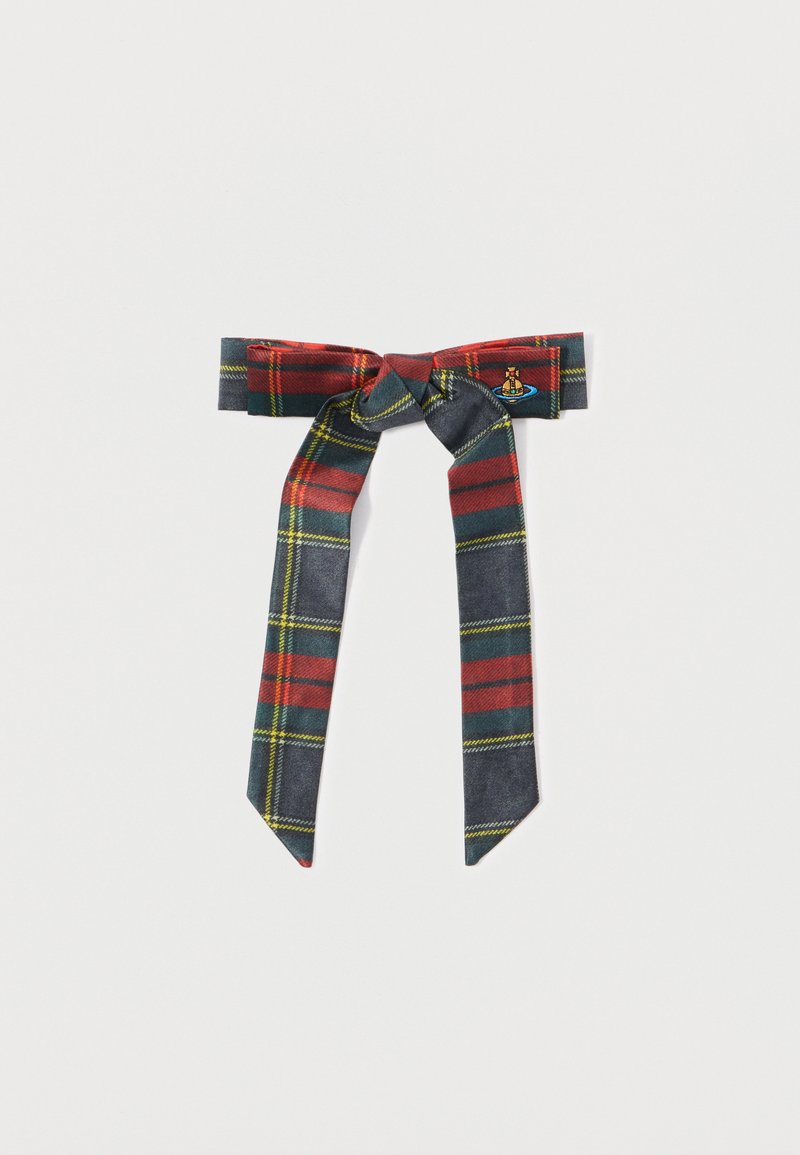 Plaid juostelė, mazgas tamsiai mėlynos, raudonos ir geltonos spalvų tonais. Yra centrinis mazgas su ilgais, siaurėjančiais galais. Vienoje pusėje yra mažas siuvinėtas logotipas.