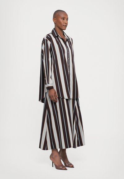 Striped shirt and skirt set with wide vertical stripes in dark brown, light blue, and orange. Long sleeves, button-up front, flowy silhouette.
