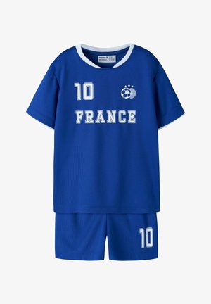 Blauw kinder voetbaluniform met witte rand, nummer "10" op borst en short, tekst "FRANCE" en een voetbal met drie sterren embleem.