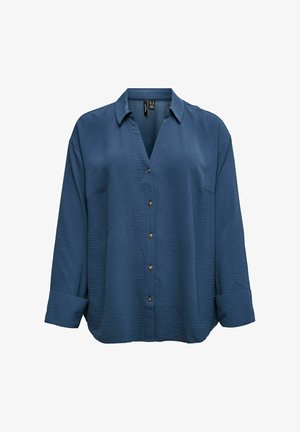 Tamsiai mėlyna marškinėliai su tekstūruota paviršiaus, v formos iškirpte, auksinėmis sagomis ir užriestomis rankovėmis. Turi vieną krūtinės kišenę.