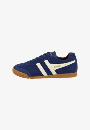 Navy blue suede sneaker with brown rubber sole, white side stripes, gold "Gola" logo, and lace-up closure, viewed from the outer side.