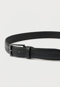 Fekete, text�úrált bőrbelt matt fekete téglalap alakú fémcsattal és két övlyukkal, fehér háttéren kiemelve.