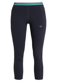 Zwarte, aansluitende sportlegging met een groene, witte en zwarte gestreepte tailleband en een klein "CK" logo op de bovenbeen.