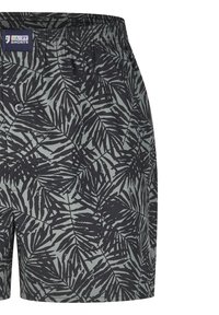 Zwarte en donkergroene stof met palmprint shorts. Beschikt over een elastische tailleband en een enkele knoopdetails bij de taille.