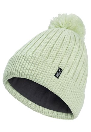 Lichtgroene gebreide wintermuts met pompon, zachte donkere voering aan de binnenkant en een Jack Wolfskin merklabel op de omgeslagen boord.