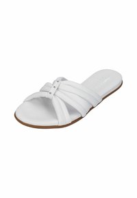 White slide sandal with multiple soft straps and silver accent studs. The sole is flat with a light brown base and smooth texture.