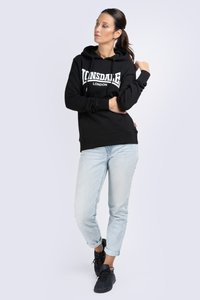 Black hoodie with white "Lonsdale London" logo, kangaroo pocket, textured fabric, paired with light blue rolled cuff jeans and black sneakers.