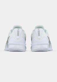 White athletic shoes with a textured upper, light mint accents, and a reflective silver logo. Features a cushioned heel and rubber sole.