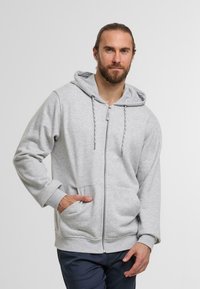 Gray zip-up hoodie with a drawstring hood, front pockets, and ribbed cuffs. Made from a soft, textured fabric.